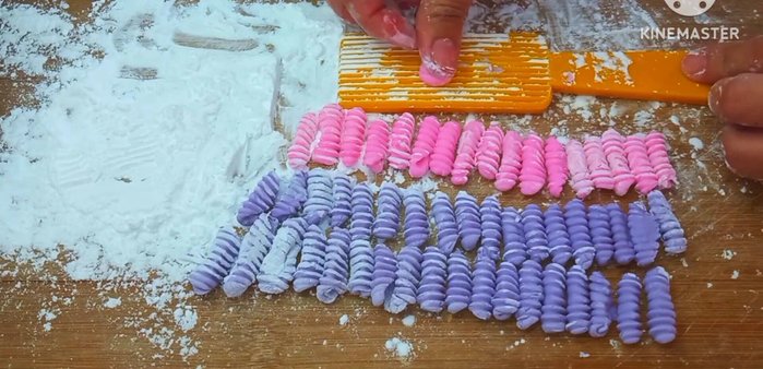 Shape the Lod Chong noodles: Use a mold dusted with tapioca flour to prevent sticking. Press a small amount of dough into the mold to create the noodle shape.