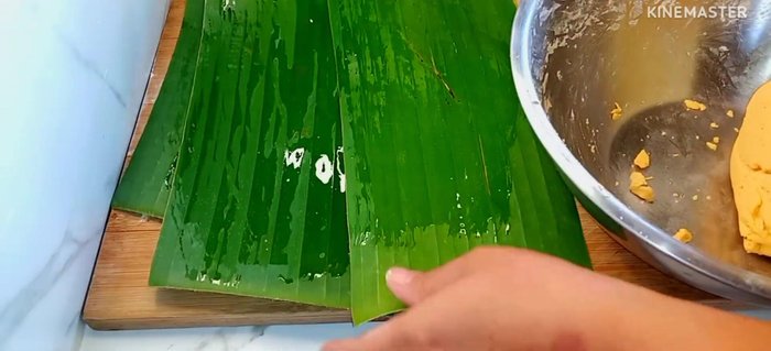 Divide the dough into 4 equal pieces. Roll each piece into a long stick and place on banana leaves.