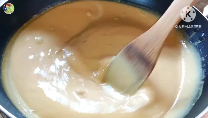 When the dough starts to thicken, reduce heat to low. Continue stirring continuously until the water dries up and the dough becomes thick and sticky.