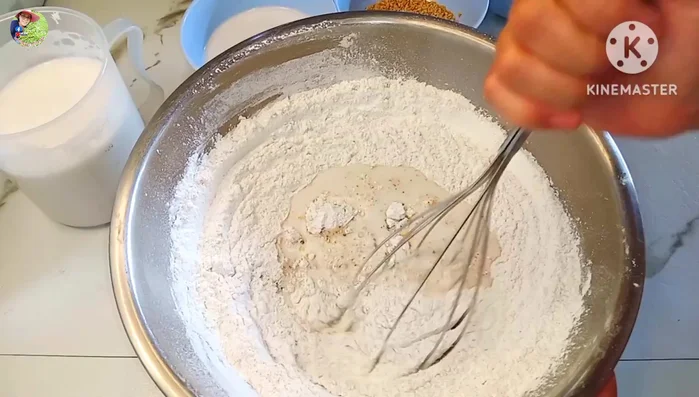 Gradually add the first portion of coconut milk (500ml), stirring to combine until the flour dissolves.