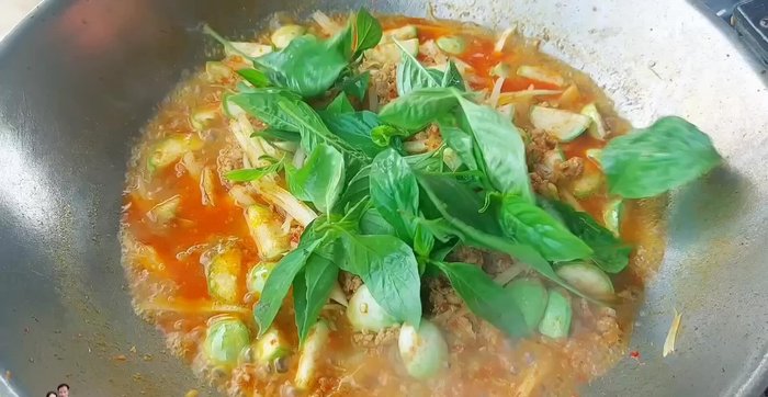 Add basil leaves and chopped chili peppers (green or red).