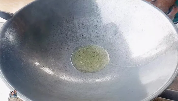 Add a little new oil to the pan, then add the pounded chilies and garlic. Stir-fry until fragrant.