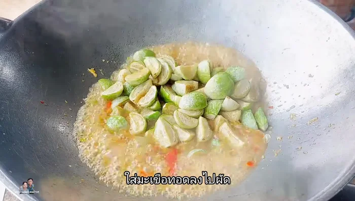 Add the fried eggplant to the pan and stir-fry until combined with the sauce.