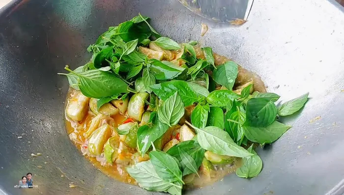 Add basil leaves and stir-fry briefly.