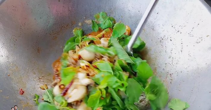 Add the holy basil leaves. Stir-fry until wilted but still vibrant green. (208.68)
