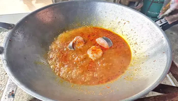 Once the water boils, add the catfish. Let it simmer until the water boils again and the bottom of the fish changes color.