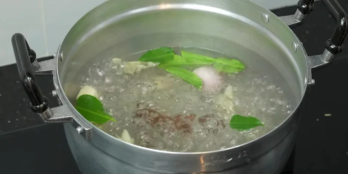 Add the chopped chicken to the boiling broth.