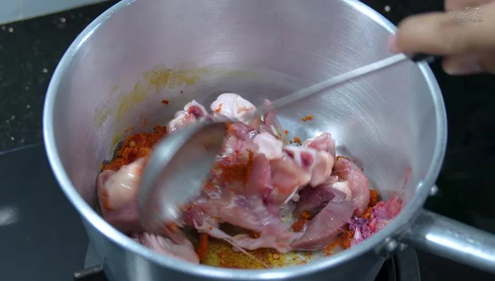 Add the chicken thighs and giblets to the pot and stir-fry with the curry paste.