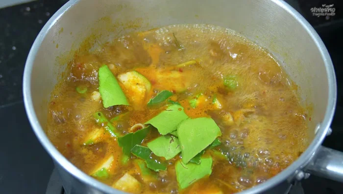 Add kaffir lime leaves and red chili peppers.