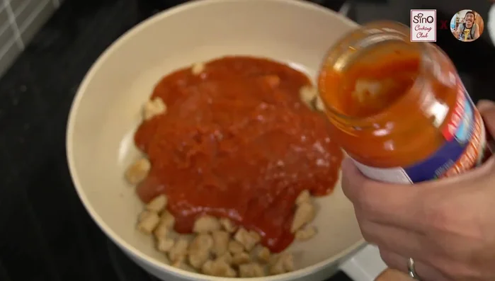 Add the Bolognese sauce to the pan. If desired, add a little water to thin the sauce.