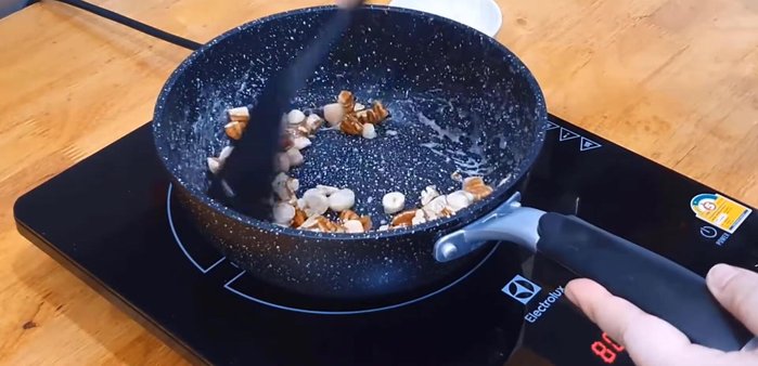 Stir-fry until well blended. The sugar will gradually coat the nuts and dry.