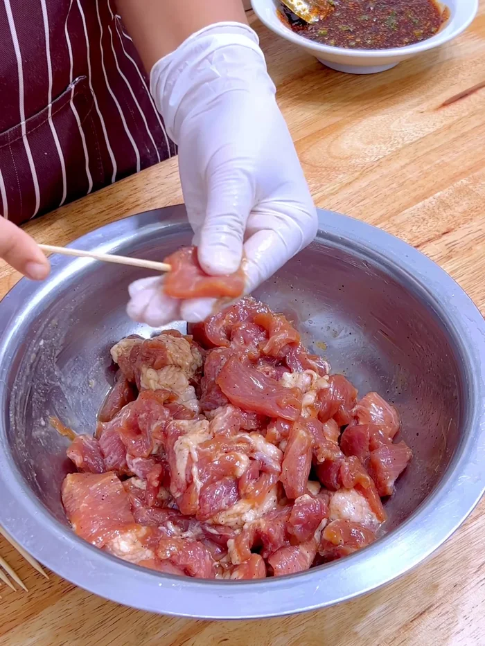 Skewer the Pork: Cut the marinated pork into bite-sized pieces and skewer about 4 pieces per skewer.