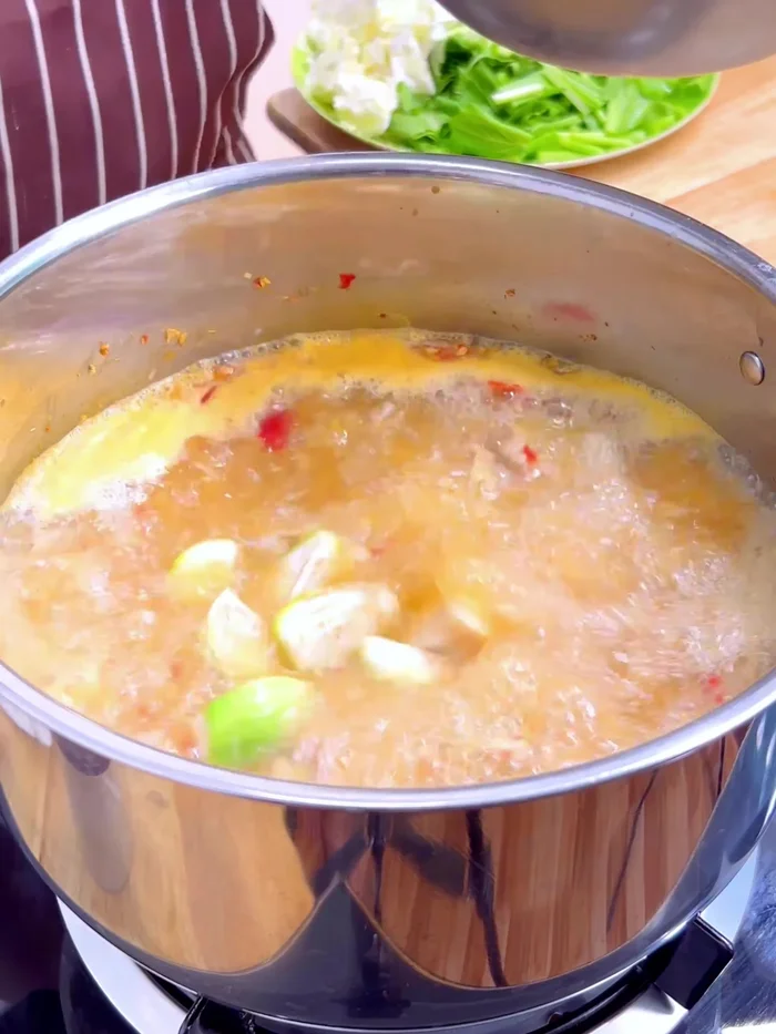Add the eggplant, stirring quickly to ensure it’s submerged in the soup to prevent discoloration. (230.599)