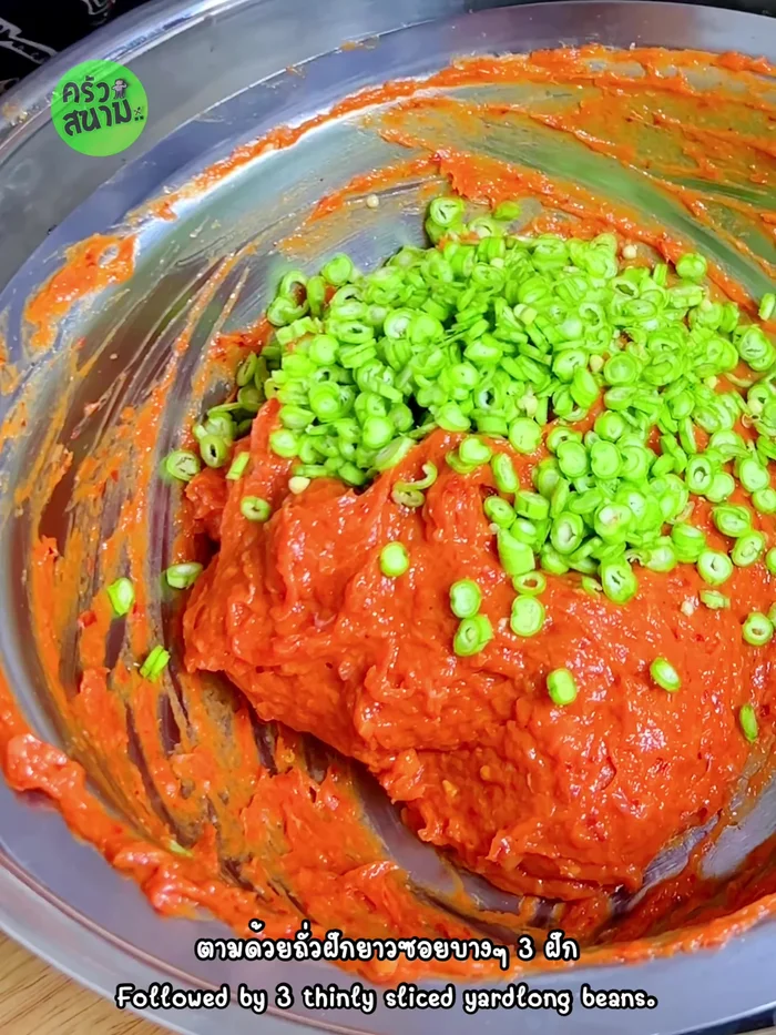 Add 3 thinly sliced long beans and 5 sliced kaffir lime leaves. Knead again until sticky.