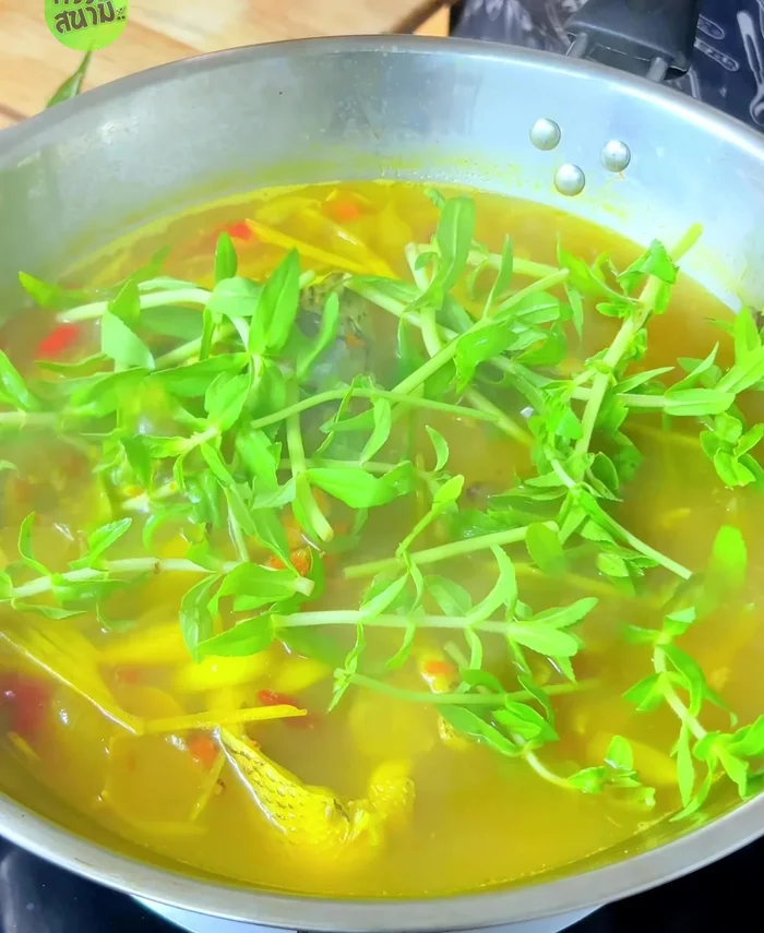 Add Chinese kale and coriander. Stir and simmer until vegetables are wilted.