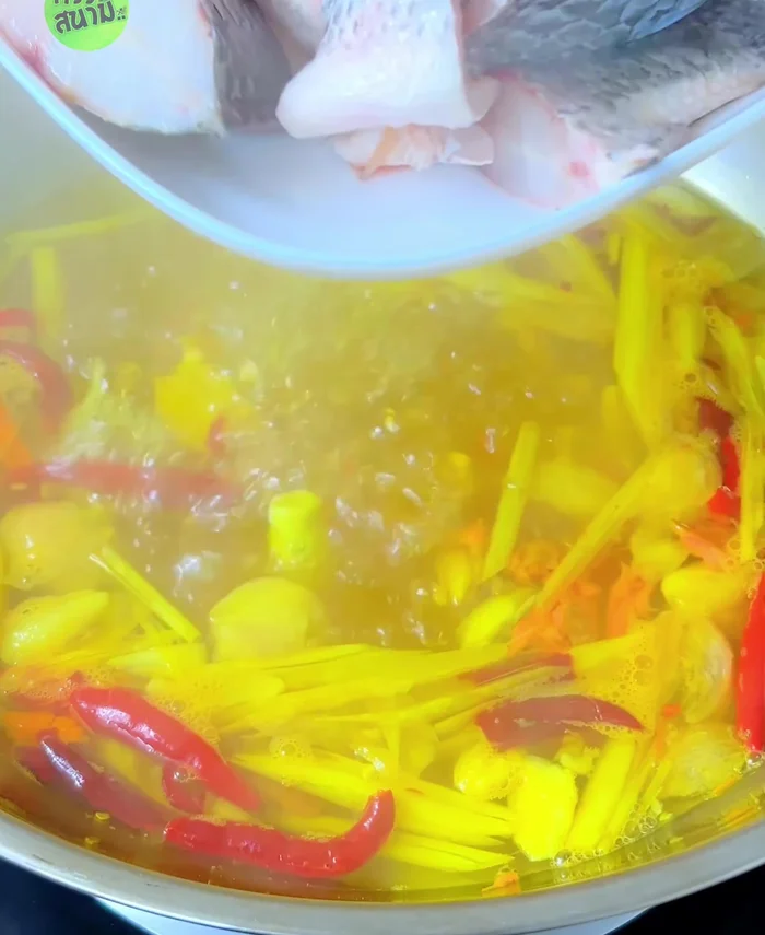 Once boiling, add the cleaned and cut tilapia. Do not stir to avoid a fishy smell.