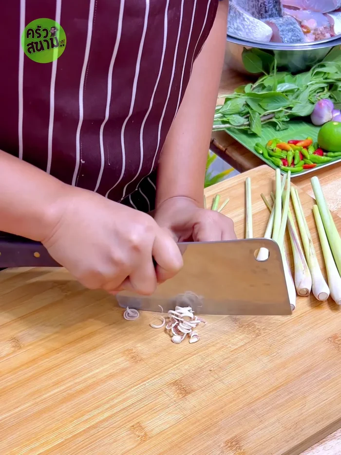 Prepare the herbs: Chop lemongrass, pound shallots, chop chili peppers.
