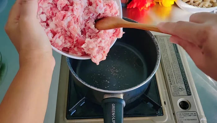 Cook minced pork until about 60% cooked. Add 1 tablespoon of fish sauce to season.