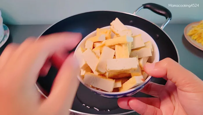 Heat oil in a pan and fry yellow tofu until golden brown and crispy. Set aside.
