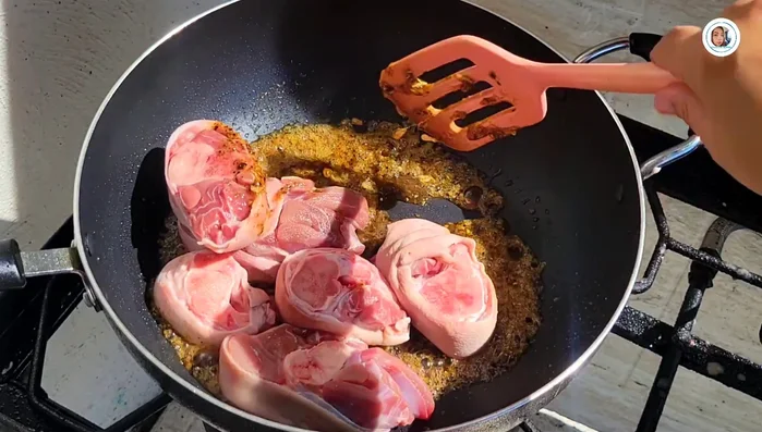 Add the cut pork leg pieces and stir-fry for 5-7 minutes until the skin tightens.