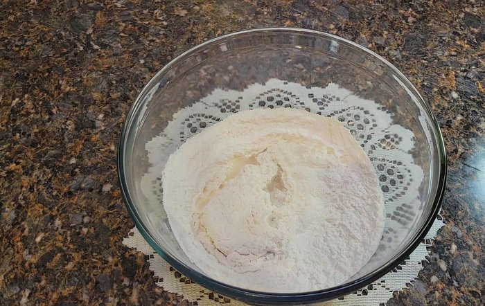 Add warm water, beaten egg, and the milk-sugar mixture. Mix well. [81.2]