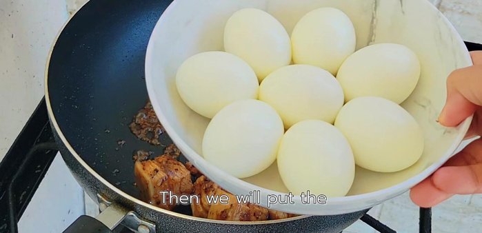 Add boiled eggs and stir-fry gently for 2-3 minutes.