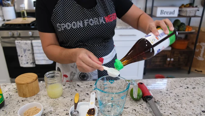 Make the salad dressing: In a bowl, whisk together fish sauce, seasoning soy sauce, lime juice, brown sugar, and chili oil. Taste and adjust seasoning as needed.
