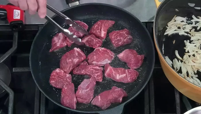 Cut chuck roast into small pieces and sear them in a hot pan (365°F) until browned on all sides.