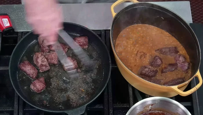 Add the seared beef and beef stock to the pan. Bring to a simmer.