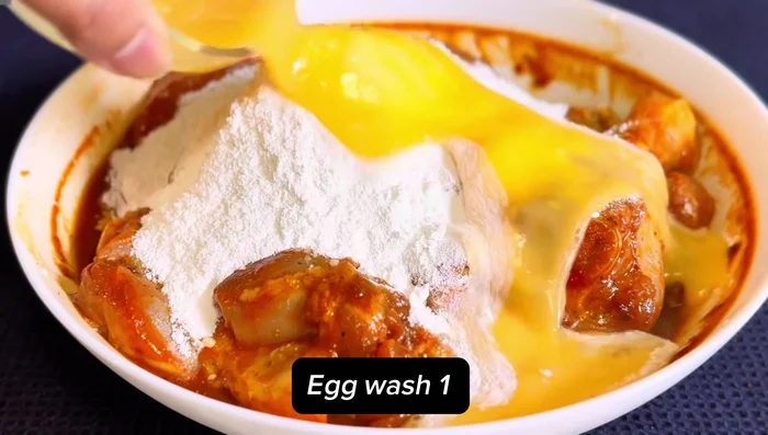 Coat the chicken with the flour mixture, then dip in egg wash.